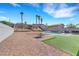 Spacious backyard featuring a pool, palm trees, gravel landscaping, and a small patch of artificial turf at 341 Waterwheel Falls Dr, Henderson, NV 89015