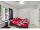 Bedroom with a tiled floor, a small desk, and a red floral comforter on the bed at 341 Waterwheel Falls Dr, Henderson, NV 89015