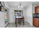 Bright breakfast nook with a tile floor, adjacent backyard views, and a dark wood dining set at 341 Waterwheel Falls Dr, Henderson, NV 89015
