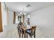 Cozy dining area with a chandelier, table with four chairs, and a view of a window at 341 Waterwheel Falls Dr, Henderson, NV 89015