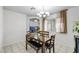 Inviting dining room with a chandelier, large dining table, and sight lines into an adjacent living space at 341 Waterwheel Falls Dr, Henderson, NV 89015