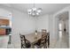 Charming dining area featuring tile floors, chandelier, and a dark wood table with seating for four at 341 Waterwheel Falls Dr, Henderson, NV 89015