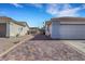 View of the side of a home with access to the backyard through an iron gate and a paved driveway at 341 Waterwheel Falls Dr, Henderson, NV 89015