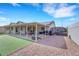 Exterior view showcasing the home's covered patio, driveway and artificial grass at 341 Waterwheel Falls Dr, Henderson, NV 89015