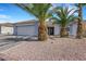 Attractive single-story home with a paved driveway, desert landscaping, and mature palm trees at 341 Waterwheel Falls Dr, Henderson, NV 89015