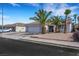Attractive single-story home with a paved driveway, desert landscaping, and mature palm trees at 341 Waterwheel Falls Dr, Henderson, NV 89015