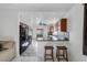 Stylish kitchen featuring a breakfast bar, modern appliances, and tile backsplash at 341 Waterwheel Falls Dr, Henderson, NV 89015
