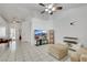 Bright living room featuring neutral tones, tile flooring, ceiling fan, and large windows at 341 Waterwheel Falls Dr, Henderson, NV 89015