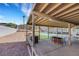 Covered outdoor living space with ample seating, overlooking the backyard pool area and desert-style landscaping at 341 Waterwheel Falls Dr, Henderson, NV 89015