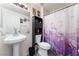 Bathroom features a single sink, toilet, and shower with modern purple curtain at 3420 Winterhaven St # 202, Las Vegas, NV 89108