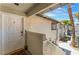 Exterior shot of front door with welcome mat, stucco walls, and views of the complex at 3420 Winterhaven St # 202, Las Vegas, NV 89108