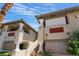 Exterior view of condo buildings with decorative columns, staircases, and red brick accents at 3420 Winterhaven St # 202, Las Vegas, NV 89108