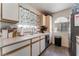 Galley kitchen featuring white cabinets, stainless steel appliances, and wood-style floors at 3420 Winterhaven St # 202, Las Vegas, NV 89108