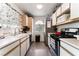Narrow galley kitchen with stainless steel appliances and white cabinetry at 3420 Winterhaven St # 202, Las Vegas, NV 89108