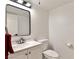 Contemporary powder room with sleek fixtures, framed mirror, and neutral color palette at 3484 Nightflower Ln # 2, Las Vegas, NV 89121