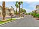 Gated community entrance with lush landscaping, mature palm trees, and well maintained grounds at 3484 Nightflower Ln # 2, Las Vegas, NV 89121