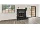 Living room fireplace is surrounded by new flooring and is next to the sliding glass doors at 3484 Nightflower Ln # 2, Las Vegas, NV 89121