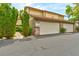 Attached garages of this townhome complex feature brick accents and well maintained landscaping at 3484 Nightflower Ln # 2, Las Vegas, NV 89121