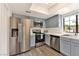 Updated kitchen featuring stainless steel appliances, white countertops and light blue cabinets at 3484 Nightflower Ln # 2, Las Vegas, NV 89121