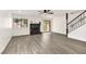 Open living area featuring new flooring, a stone fireplace, and staircase to the second floor at 3484 Nightflower Ln # 2, Las Vegas, NV 89121