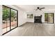 Bright living room with modern floors, sliding glass doors, and a stone fireplace at 3484 Nightflower Ln # 2, Las Vegas, NV 89121