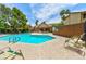 Relaxing community pool with a seating area, lounge chairs and a pergola at 3484 Nightflower Ln # 2, Las Vegas, NV 89121