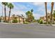 Street view of a well-maintained community showcasing mature palm trees and landscaped common areas at 3484 Nightflower Ln # 2, Las Vegas, NV 89121
