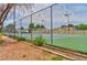 Community tennis court features green surface, metal fence, and is surrounded by landscaping at 3484 Nightflower Ln # 2, Las Vegas, NV 89121