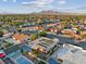 An aerial view of a residential neighborhood with lush trees and mountain views at 3625 Barcelona St, Las Vegas, NV 89121