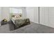This bedroom features neutral carpet, a bed with green accents, and a double door closet at 3625 Barcelona St, Las Vegas, NV 89121