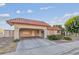 View of the home's front exterior featuring a terracotta tile roof and a covered carport area at 3625 Barcelona St, Las Vegas, NV 89121