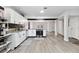 Spacious open-concept kitchen with white cabinets, stainless appliances, and wood flooring at 3625 Barcelona St, Las Vegas, NV 89121