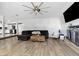 Spacious living room with modern flooring, a fireplace, and a large ceiling fan at 3625 Barcelona St, Las Vegas, NV 89121