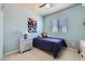 Inviting bedroom with blue walls, a comfortable bed, and a side table for personal items at 3642 Winter Whitetail St, Las Vegas, NV 89122