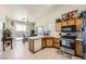 Well-lit kitchen with wood cabinets, stainless appliances, and an adjacent dining area with sliding glass doors at 3642 Winter Whitetail St, Las Vegas, NV 89122