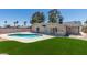 Spacious backyard features a pool, artificial grass, mature trees and plenty of space to enjoy the outdoors at 3986 Belleville Ave, Las Vegas, NV 89121