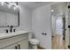 Bathroom with a modern vanity, sleek fixtures, and a view into the hallway at 3986 Belleville Ave, Las Vegas, NV 89121