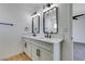 Bright bathroom featuring double sinks, white countertops, and modern fixtures at 3986 Belleville Ave, Las Vegas, NV 89121