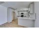 Modern kitchen with white cabinets, stainless steel appliances, and light wood flooring at 3986 Belleville Ave, Las Vegas, NV 89121