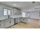 Bright kitchen boasts white cabinets and stainless steel appliances, open to dining and living areas at 3986 Belleville Ave, Las Vegas, NV 89121