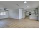 Spacious living area with light wood floors adjacent to a modern kitchen at 3986 Belleville Ave, Las Vegas, NV 89121