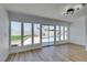 Bright living room with hardwood floors and sliding glass doors view of pool at 3986 Belleville Ave, Las Vegas, NV 89121