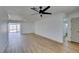 Spacious living room with light hardwood floors and a modern ceiling fan at 3986 Belleville Ave, Las Vegas, NV 89121