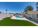 Backyard oasis showcasing a sparkling pool, lush turf, and privacy fencing at 3986 Belleville Ave, Las Vegas, NV 89121