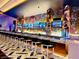 Modern bar area featuring multiple TVs, a variety of drinks, and comfortable seating along the counter at 4381 W Flamingo Rd # 2220, Las Vegas, NV 89103