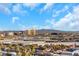 Scenic city view of Las Vegas highlighting well-known resorts and arenas, set against a backdrop of mountains and a partly cloudy sky at 4381 W Flamingo Rd # 2220, Las Vegas, NV 89103