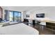 Contemporary living space offers a city view, a comfortable seating area with entertainment unit and desk at 4381 W Flamingo Rd # 2220, Las Vegas, NV 89103