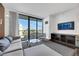 Comfortable living space offers a relaxing seating area, an entertainment unit, and a panoramic city view from the balcony at 4381 W Flamingo Rd # 2220, Las Vegas, NV 89103