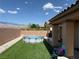 Inviting backyard with a round swimming pool and low-maintenance artificial grass at 4780 Lorenzo Way, Pahrump, NV 89061
