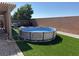 Spacious backyard with a pool, artificial grass, and a shaded patio area at 4780 Lorenzo Way, Pahrump, NV 89061